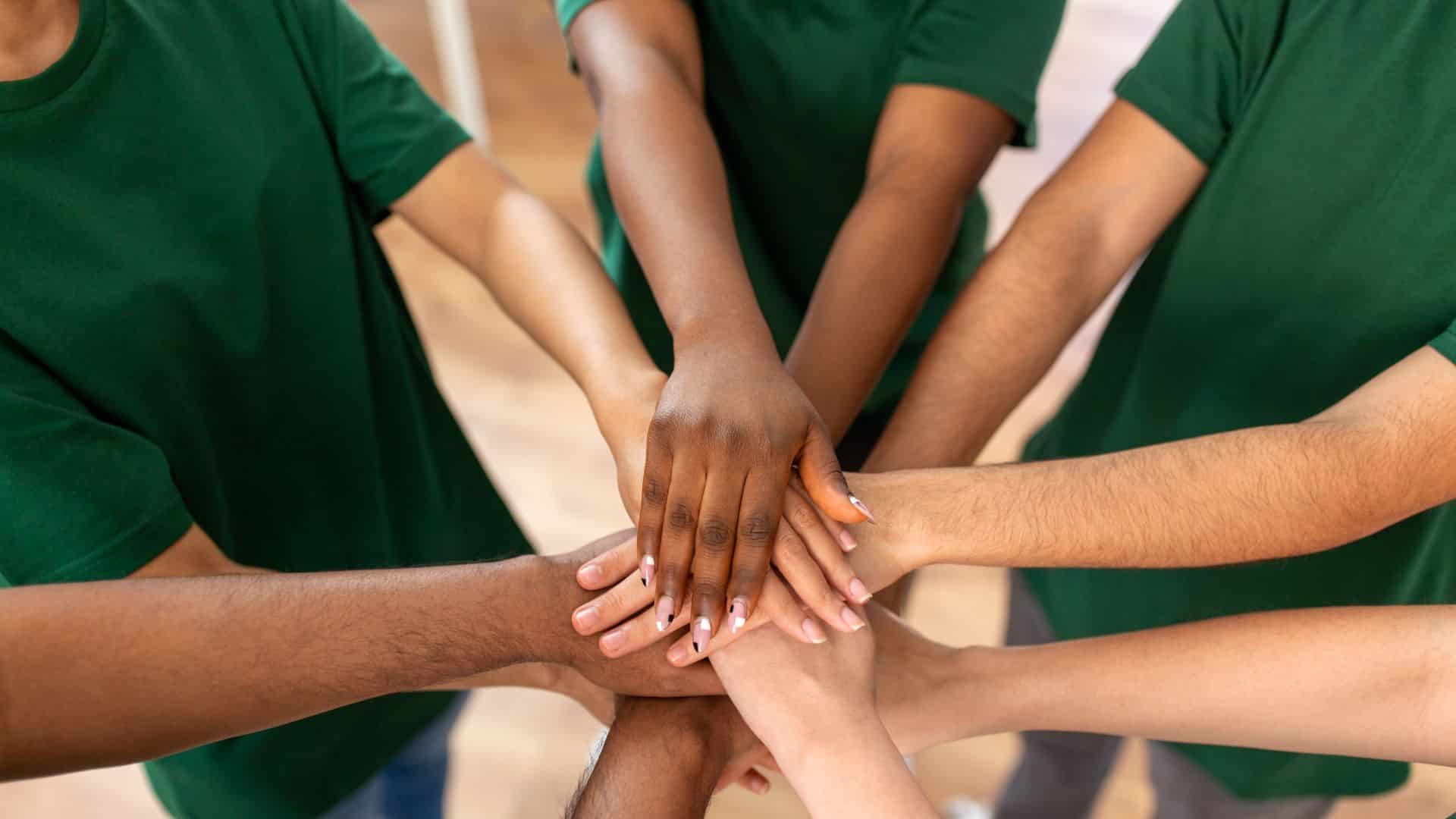 team hands over the other